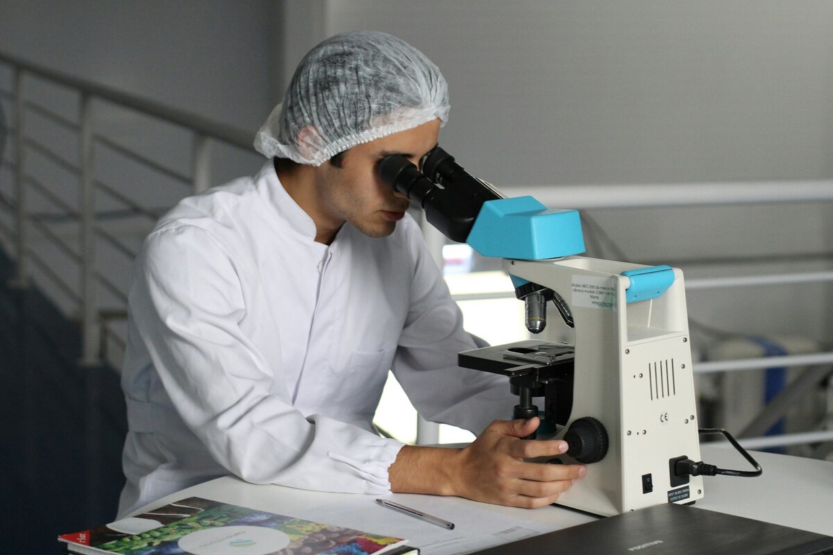 A researcher at a microscope